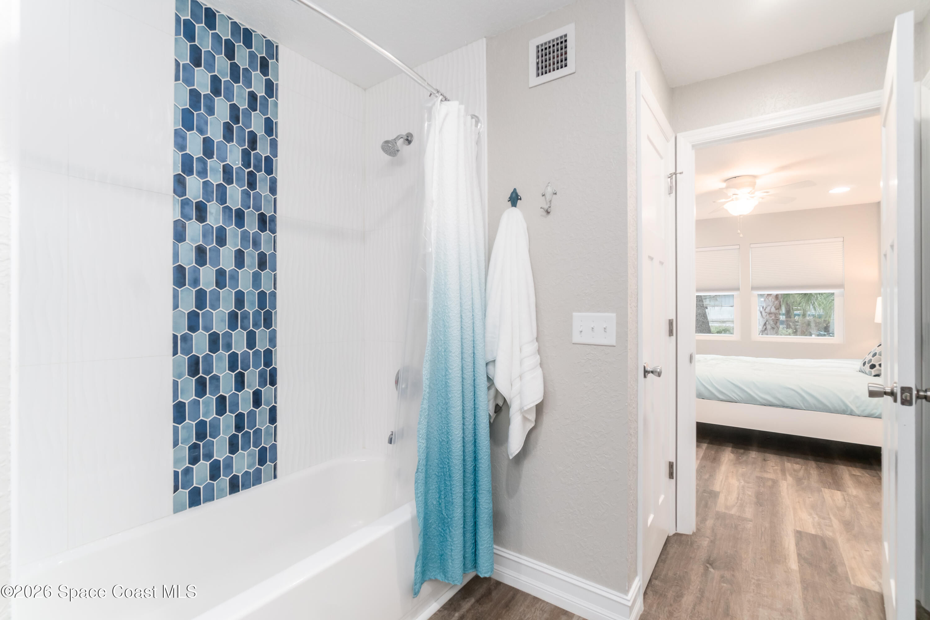 1981 Guava Avenue, Unit 104 Melbourne, FL 32935 - Photo 8 of 20 a en suite bathroom with a bathtub and a shower