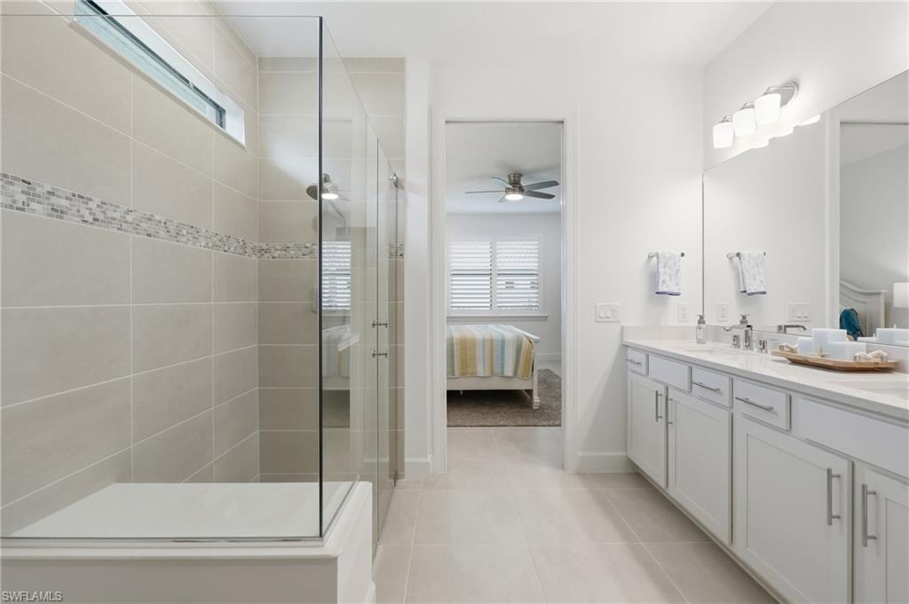 18364 Ridgeline Drive Estero, FL 33928 - Photo 23 of 50 a bathroom with a double vanity sink and mirror