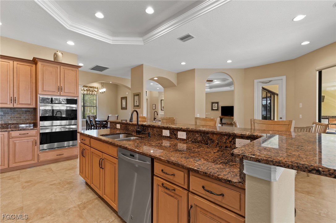 6057 Calusa Rdg Trail Bokeelia, FL 33922 - Photo 9 of 45 a kitchen with stainless steel appliances granite countertop a sink a stove and a refrigerator
