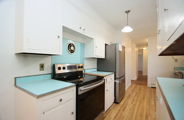 a kitchen with a sink a stove and a refrigerator