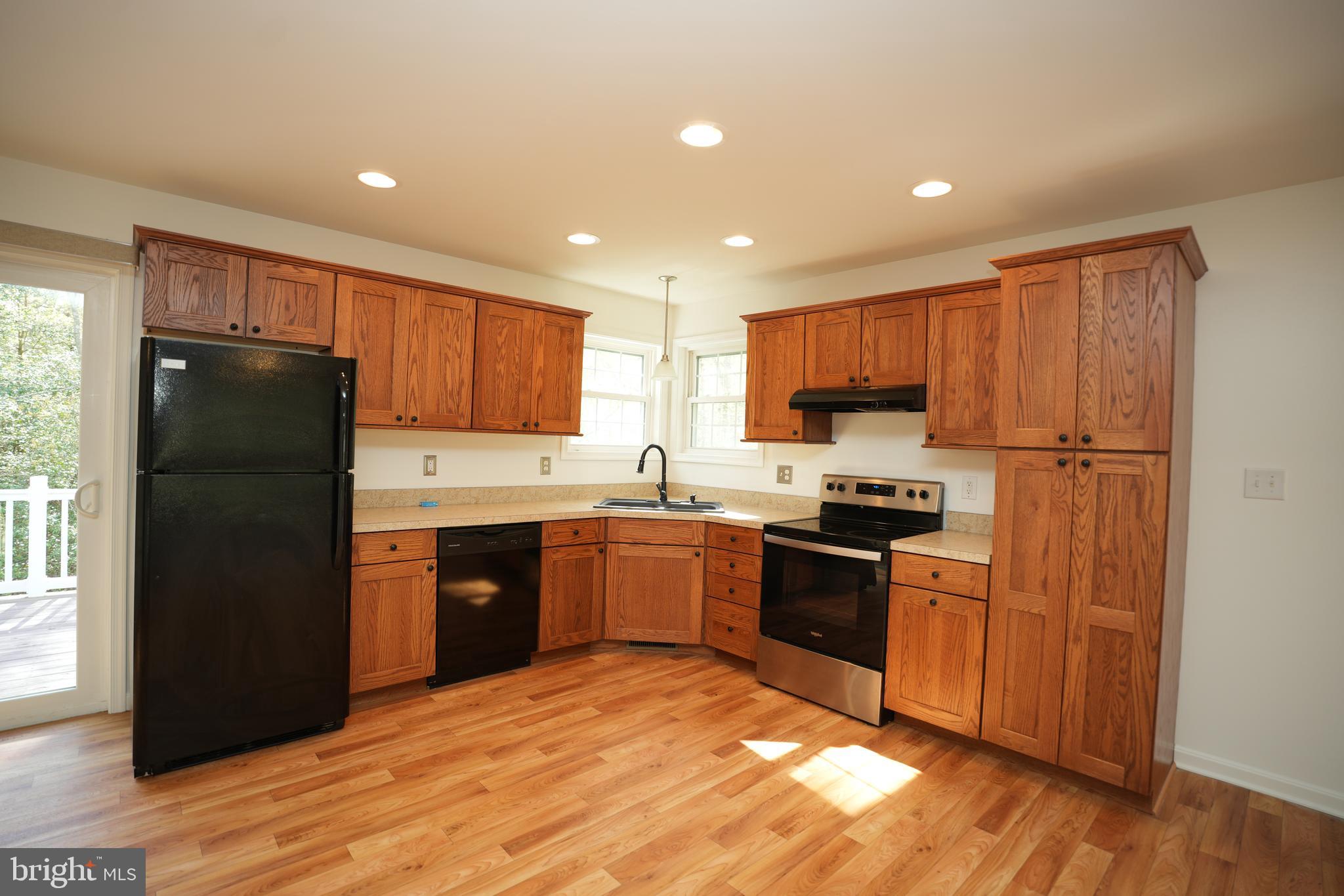 18871 Three Notch Road Lexington Park, MD 20653 - Photo 12 of 34 a kitchen with granite countertop stainless steel appliances and wooden cabinets
