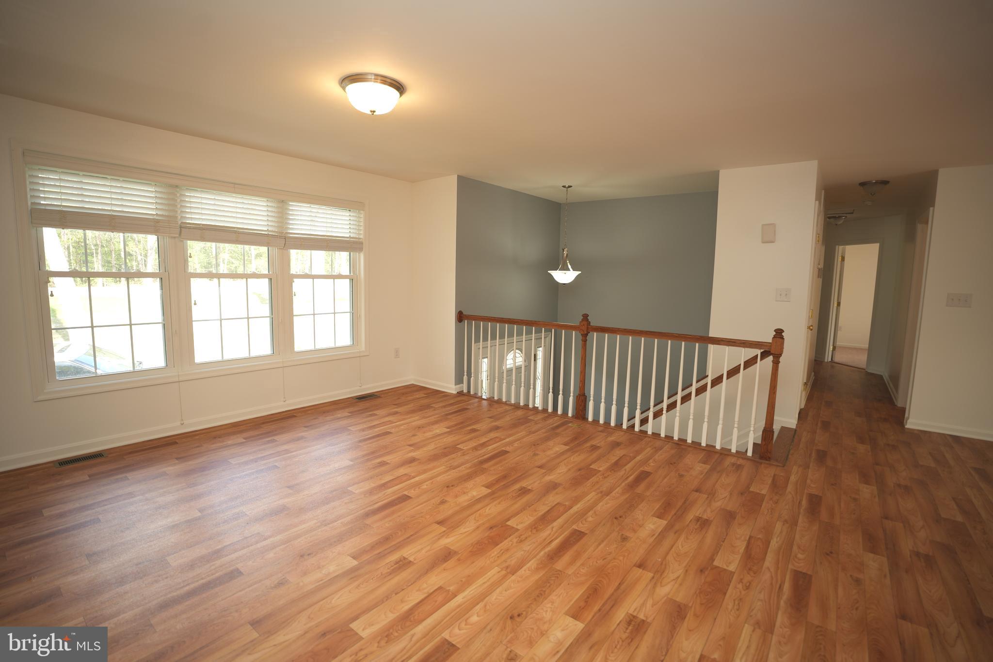 18871 Three Notch Road Lexington Park, MD 20653 - Photo 17 of 34 a view of an empty room with wooden floor and a window