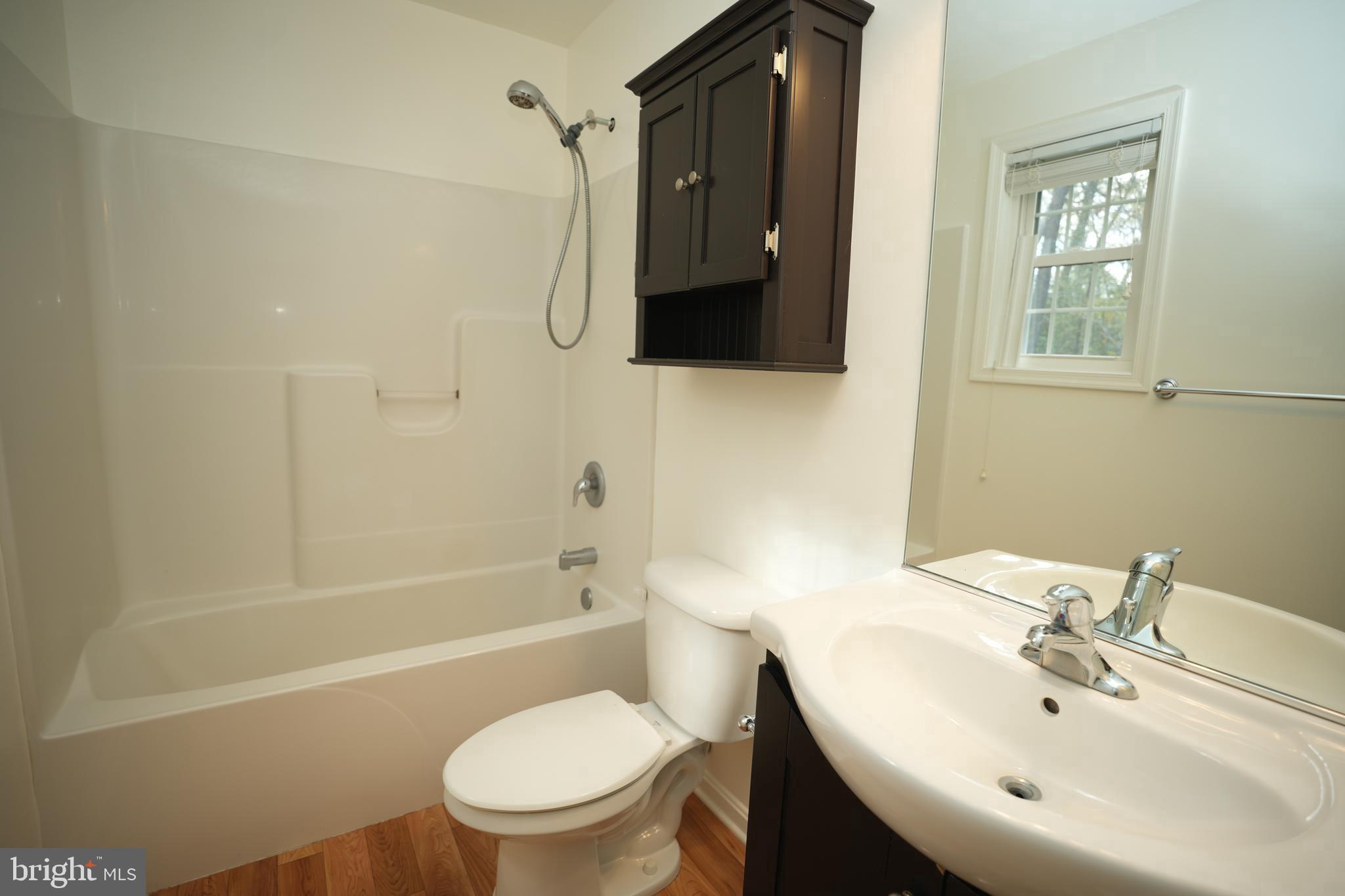 18871 Three Notch Road Lexington Park, MD 20653 - Photo 19 of 34 a bathroom with a sink toilet and shower