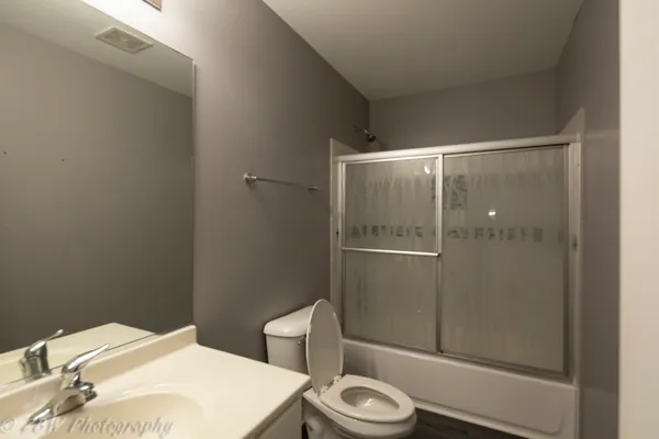 a bathroom with a toilet a sink and shower