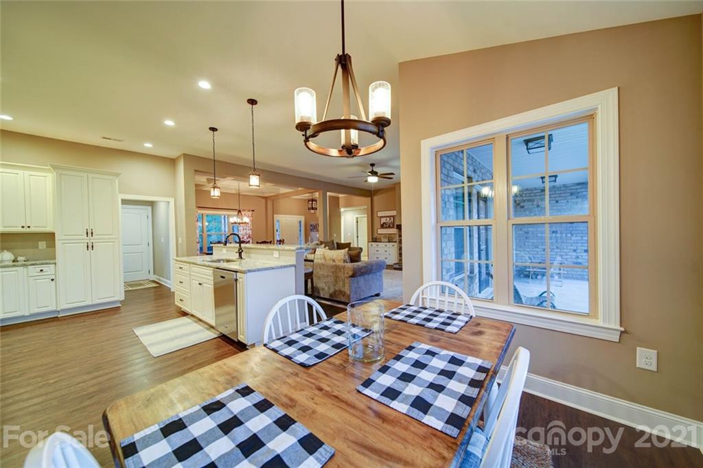 5801 Sikes Mill Road Monroe, NC 28110 - Photo 12 of 41 a living room with a dining table and a chandelier