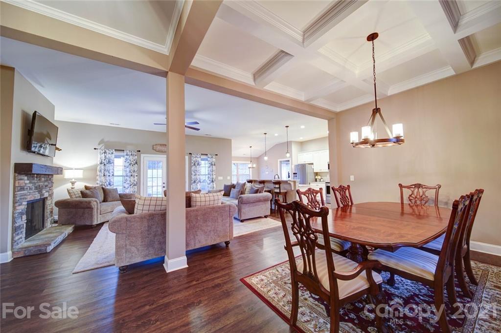 5801 Sikes Mill Road Monroe, NC 28110 - Photo 14 of 41 a view of a dining room and livingroom with furniture wooden floor a chandelier