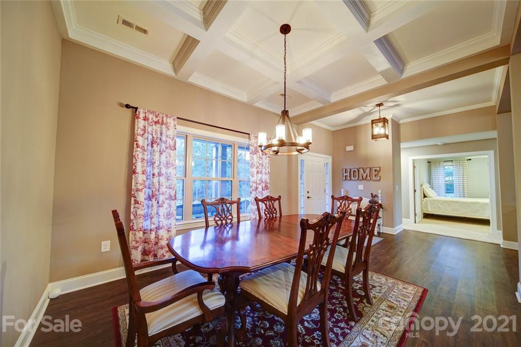 5801 Sikes Mill Road Monroe, NC 28110 - Photo 16 of 41 a view of a dining room with furniture and wooden floor