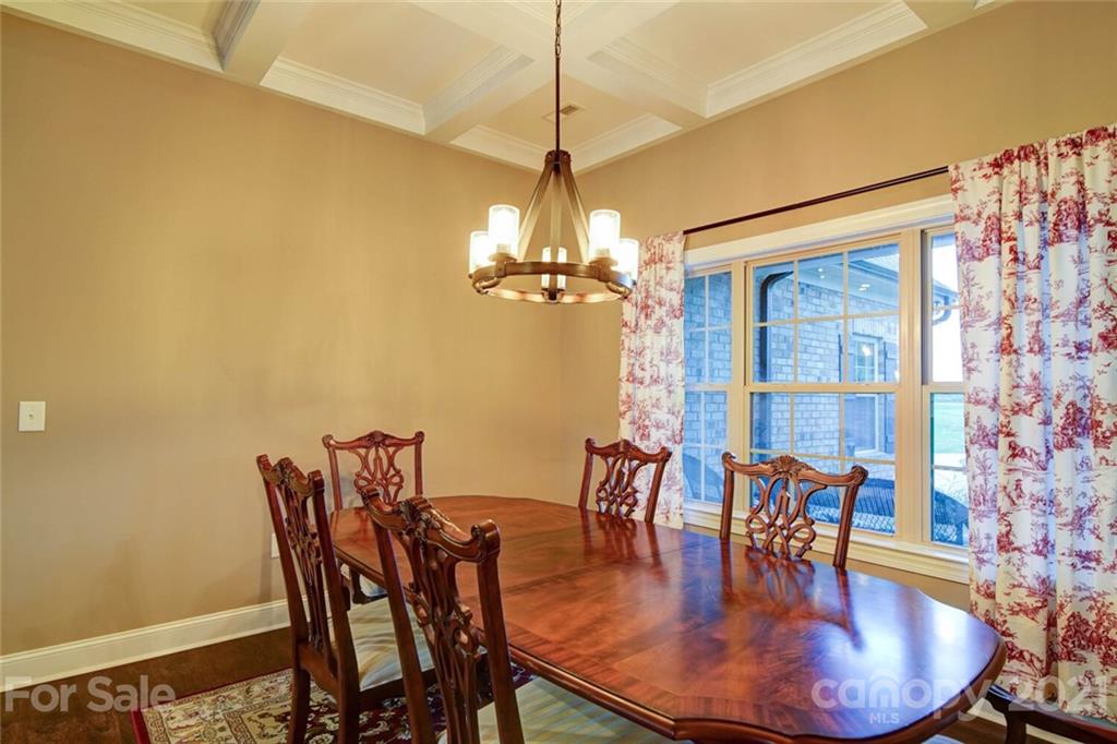 5801 Sikes Mill Road Monroe, NC 28110 - Photo 17 of 41 a dining room with furniture a chandelier and wooden floor