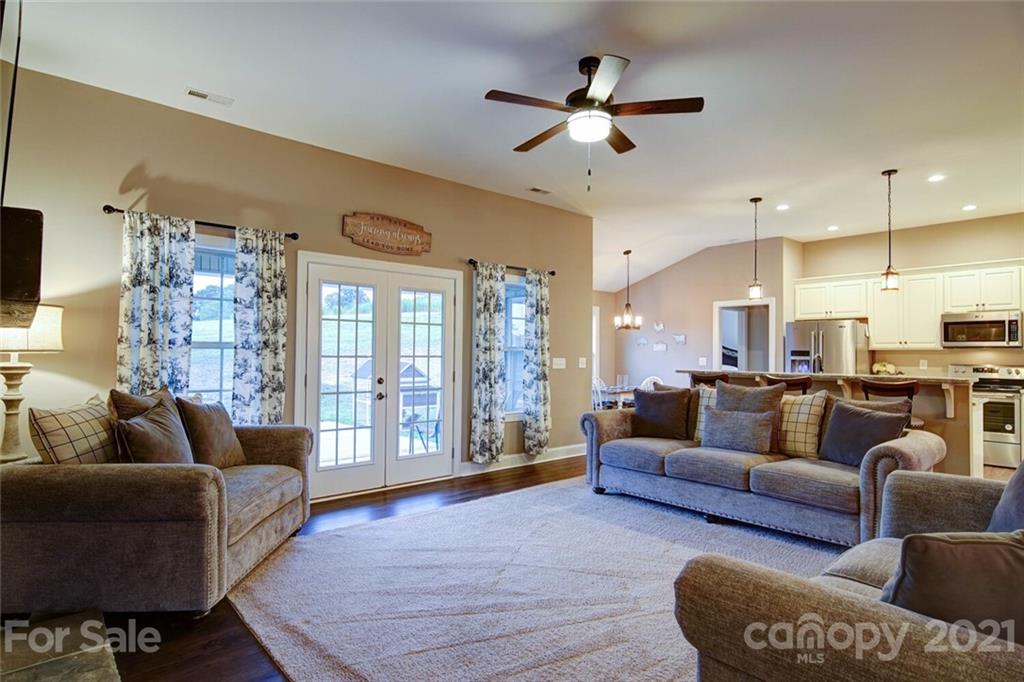 5801 Sikes Mill Road Monroe, NC 28110 - Photo 21 of 41 a living room with furniture ceiling fan and a rug