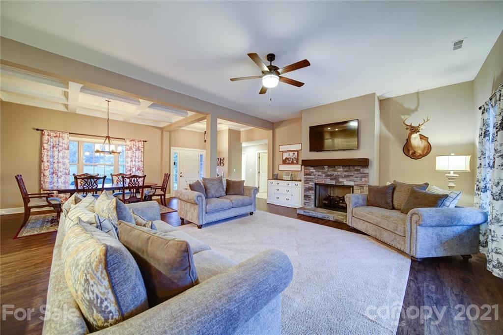 5801 Sikes Mill Road Monroe, NC 28110 - Photo 23 of 41 a living room with furniture a fireplace and a flat screen tv
