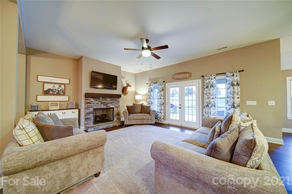 5801 Sikes Mill Road Monroe, NC 28110 - Photo 26 of 41 a living room with furniture a fireplace and a flat screen tv