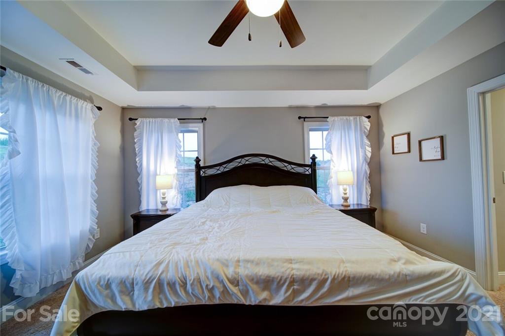 5801 Sikes Mill Road Monroe, NC 28110 - Photo 29 of 41 a bedroom with a bed and a large mirror