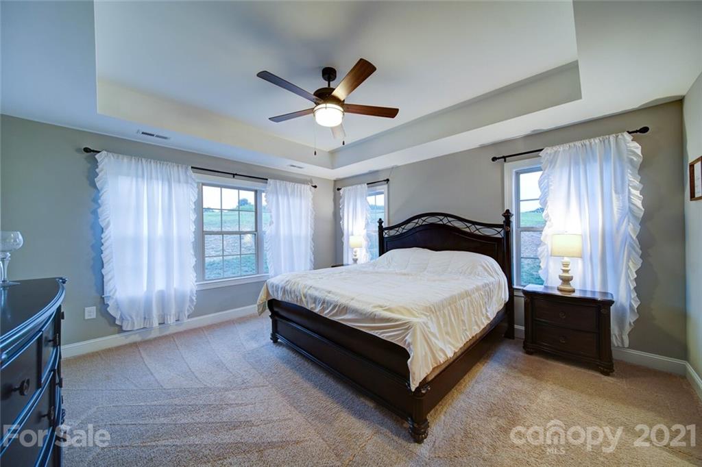 5801 Sikes Mill Road Monroe, NC 28110 - Photo 30 of 41 a spacious bedroom with a bed and a window