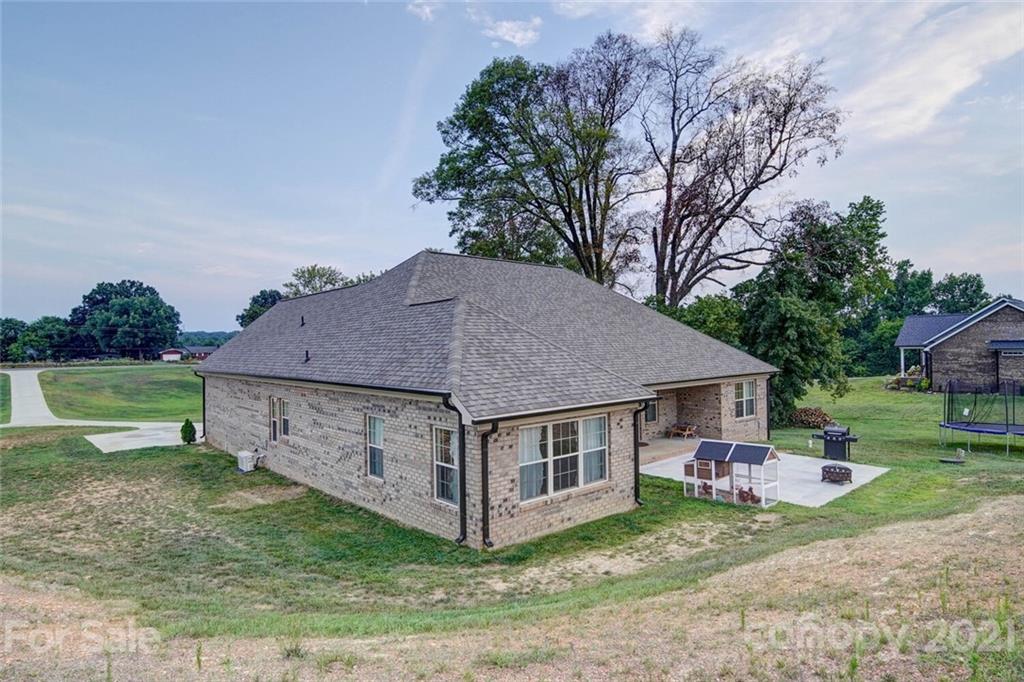 5801 Sikes Mill Road Monroe, NC 28110 - Photo 4 of 41 a aerial view of a house with a yard table and chairs