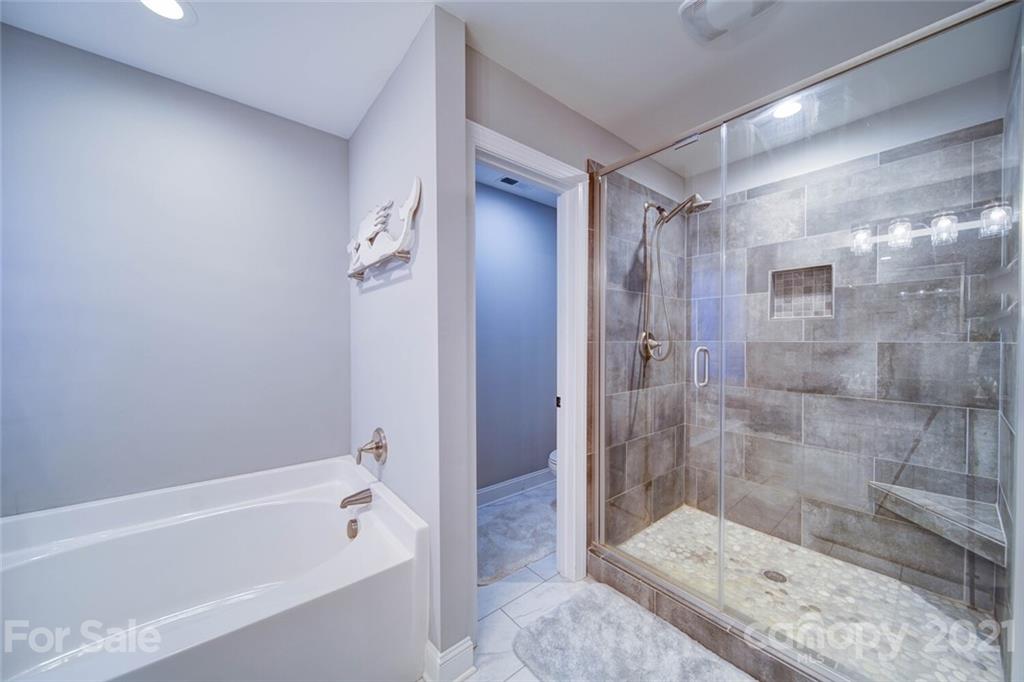 5801 Sikes Mill Road Monroe, NC 28110 - Photo 32 of 41 a bathroom with a bathtub and a shower