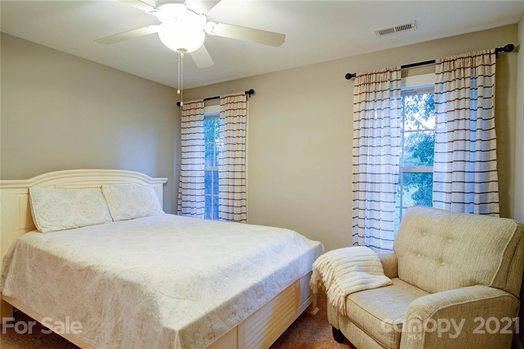5801 Sikes Mill Road Monroe, NC 28110 - Photo 38 of 41 a bedroom with a bed and a couch