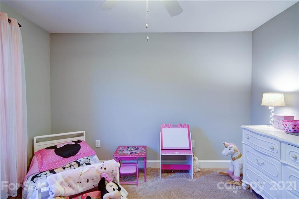 5801 Sikes Mill Road Monroe, NC 28110 - Photo 39 of 41 a bedroom with a bed and a dresser