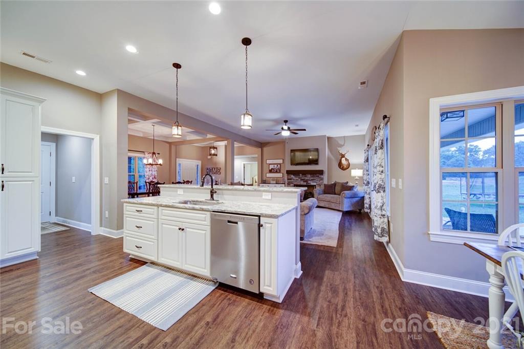 5801 Sikes Mill Road Monroe, NC 28110 - Photo 6 of 41 a open kitchen with stainless steel appliances granite countertop a lot of cabinets and wooden floors