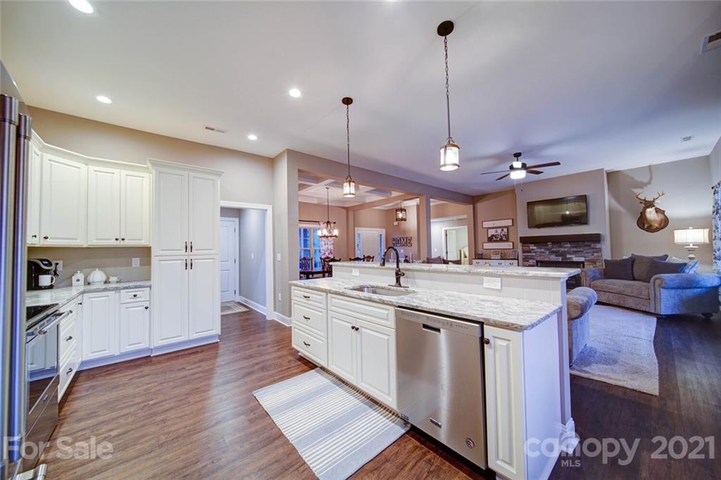 5801 Sikes Mill Road Monroe, NC 28110 - Photo 10 of 41 a kitchen with stainless steel appliances granite countertop a sink a stove and a wooden floors