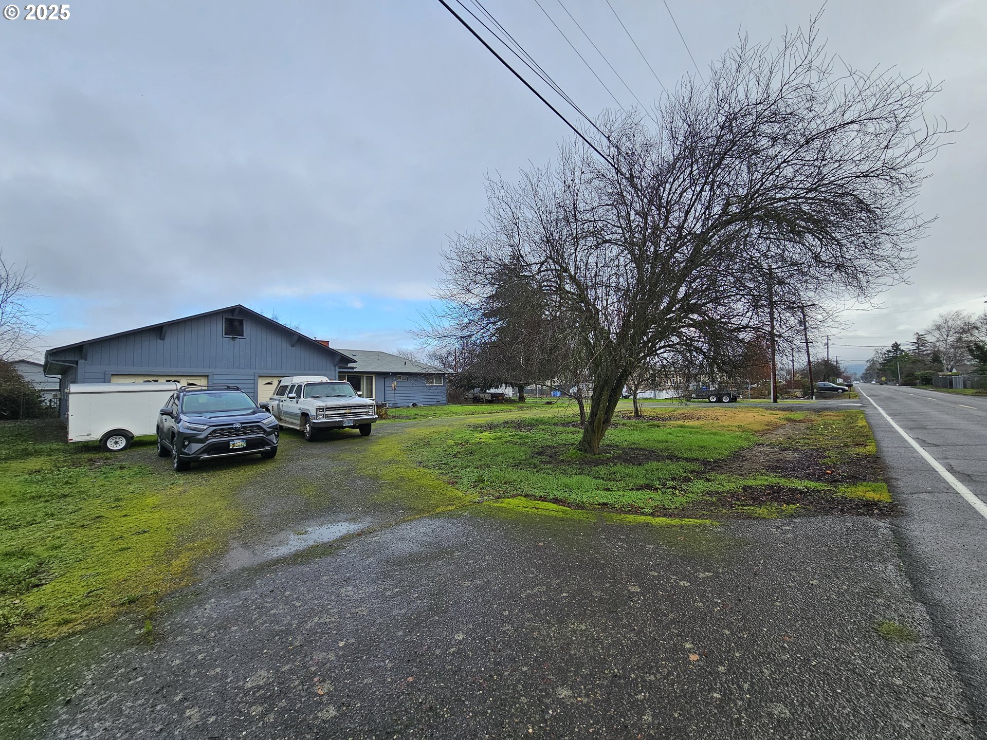 2462 Austin Road Roseburg, OR 97471 - Photo 2 of 36 a view of a house with big yard and large trees