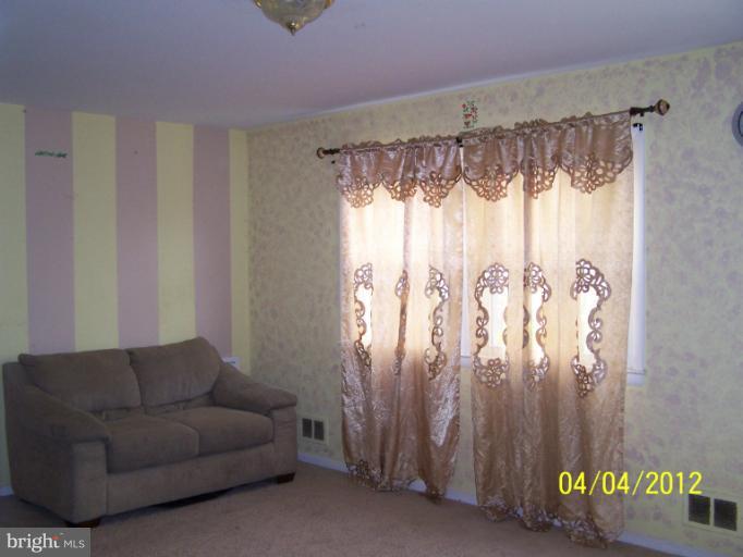 8704 Geren Road Silver Spring, MD 20901 - Photo 7 of 15 a living room with furniture and a chandelier