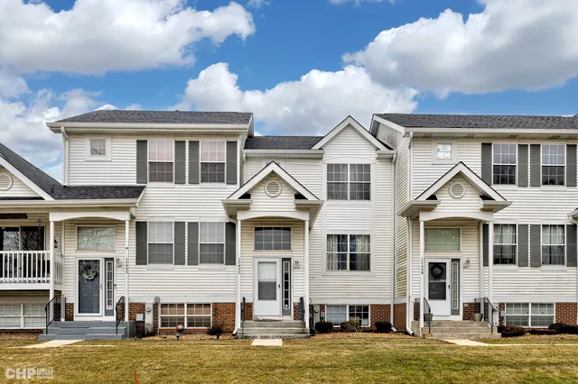 a front view of a house with a large window and a fireplace