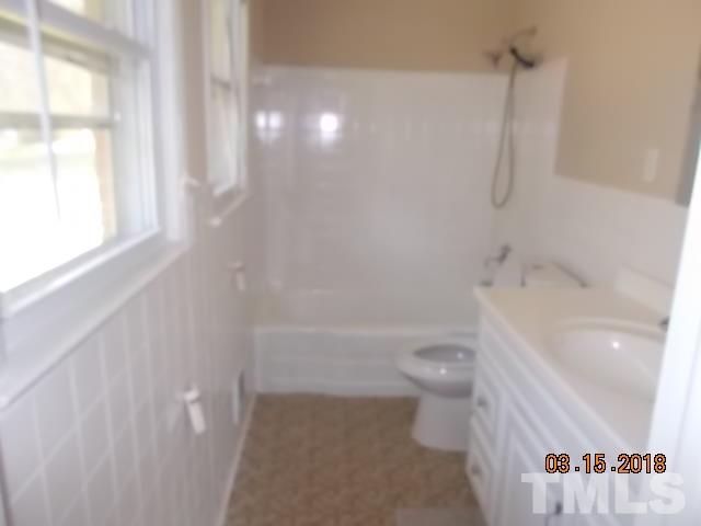 3933 Buffaloe Road Raleigh, NC 27604 - Photo 16 of 16 a bathroom with a toilet and a shower