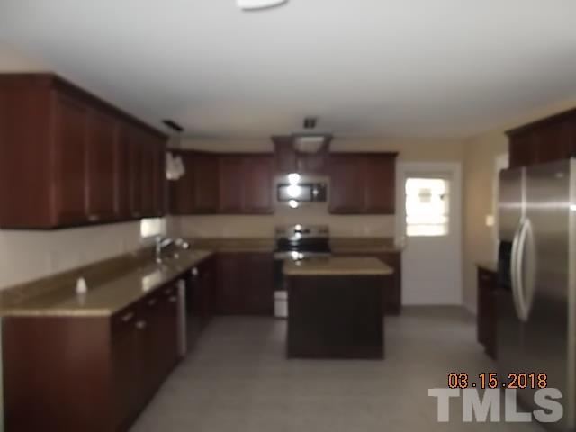 3933 Buffaloe Road Raleigh, NC 27604 - Photo 6 of 16 a kitchen with refrigerator and cabinets
