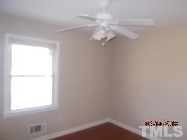 3933 Buffaloe Road Raleigh, NC 27604 - Photo 8 of 16 an empty room with a window
