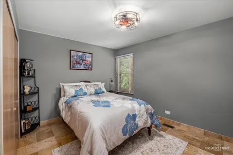 a bedroom with a bed and a painting on the wall