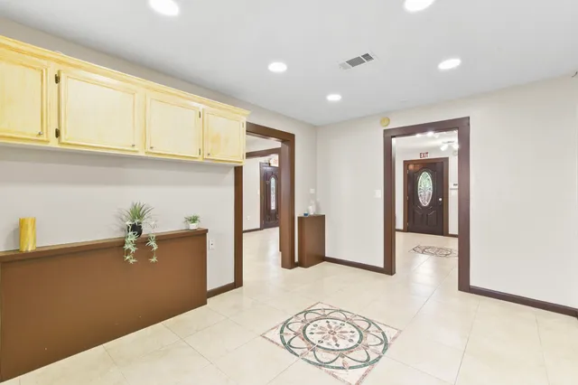 a kitchen with a refrigerator and cabinets