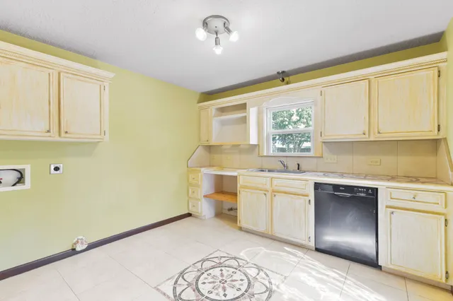 a kitchen with a sink cabinets and window