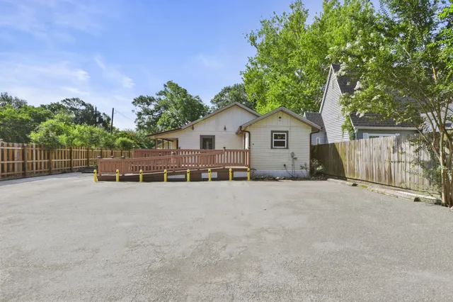 a view of a house with a backyard and trees