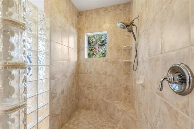 a dining room with wooden floor a chandelier a wooden table and chairs