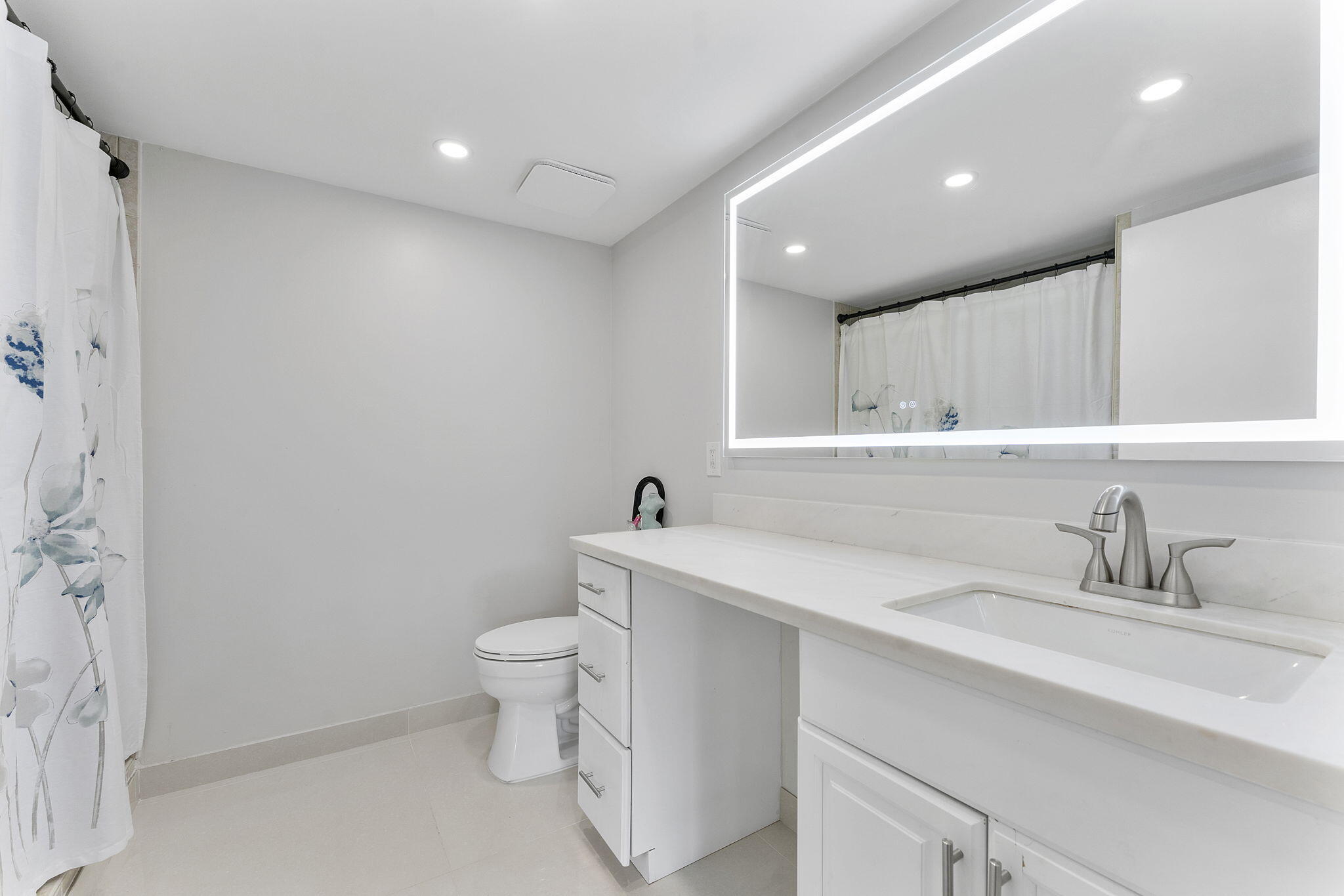 6314 Longboat Lane West, Unit 102 Boca Raton, FL 33433 - Photo 16 of 24 a bathroom with a sink toilet and a mirror