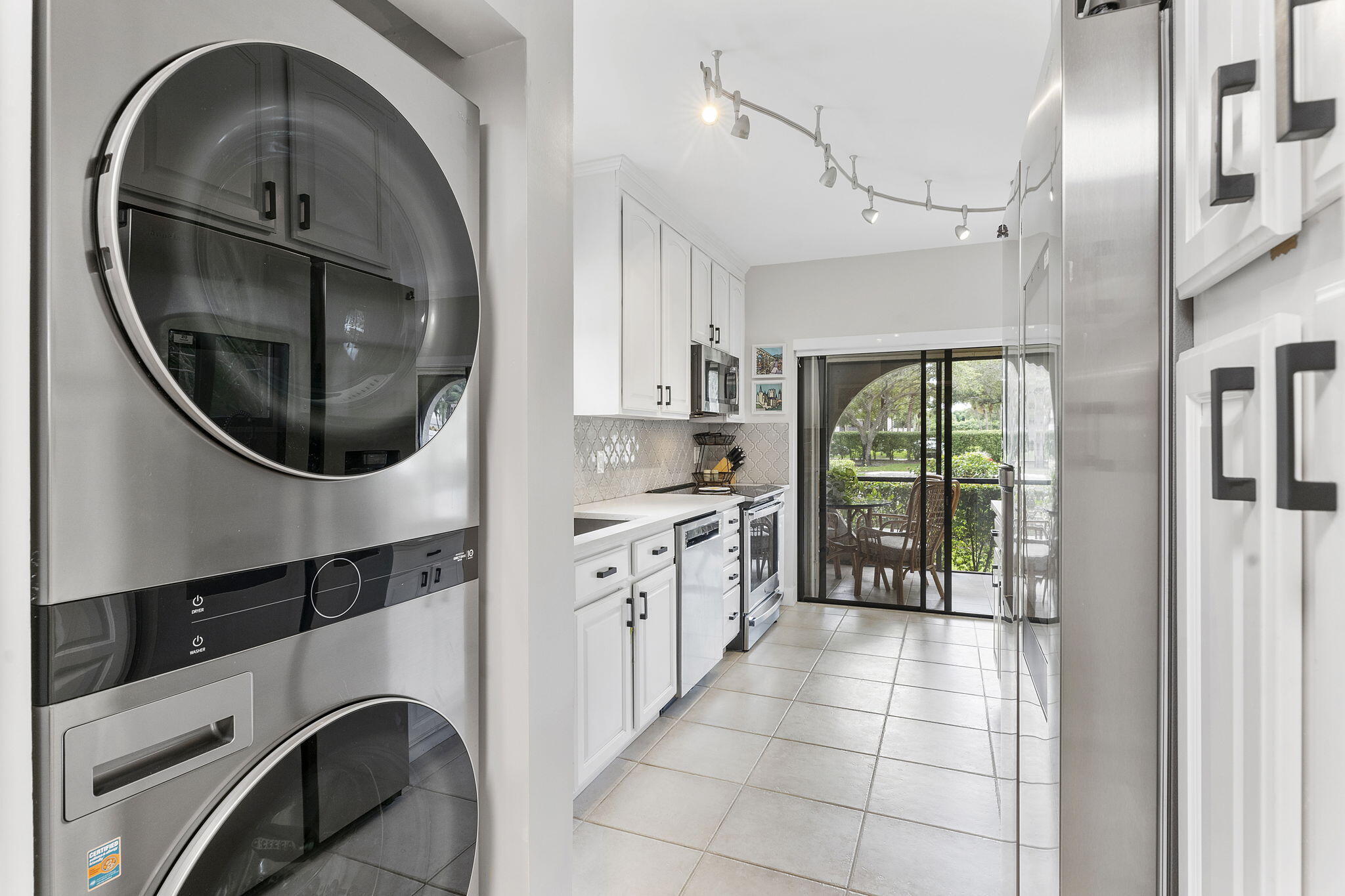 6314 Longboat Lane West, Unit 102 Boca Raton, FL 33433 - Photo 8 of 24 a kitchen with a sink and a mirror