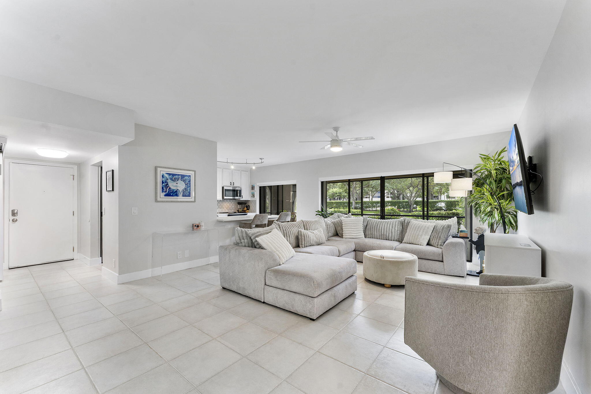 6314 Longboat Lane West, Unit 102 Boca Raton, FL 33433 - Photo 10 of 24 a living room with furniture and a large window