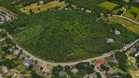 an aerial view of a residential houses with outdoor space and street view