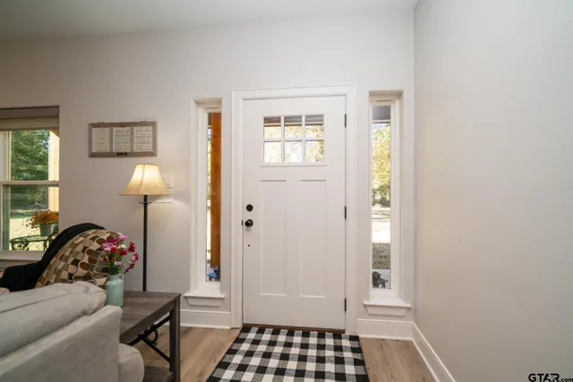 a bed room with a bed a television and a large window