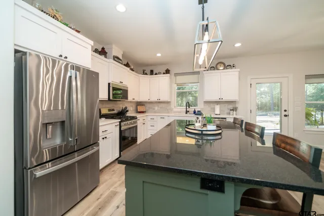 a bathroom with a sink toilet a mirror and shower