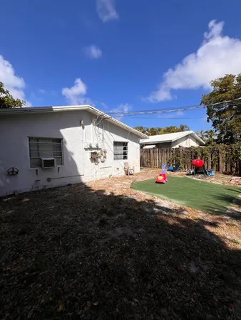 a view of house with outdoor space and fire pit