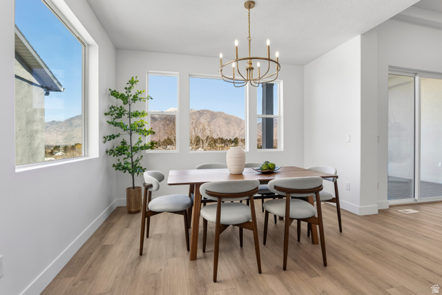 624 North Legend Circle, Unit 480 Mapleton, UT 84664 - Photo 18 of 34 Dining area with a mountain view, a chandelier, light wood-style floors, and healthy amount of natural light