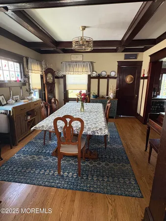a table room with stainless steel appliances furniture rug and wooden floor