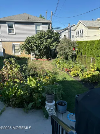 a view of a house with a yard and garden