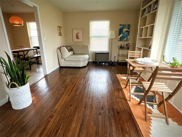 a living room with furniture and wooden floor
