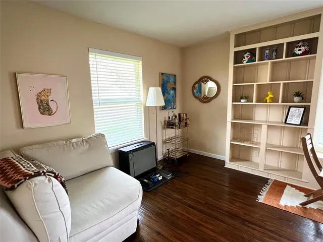 a living room with furniture window and wooden floor