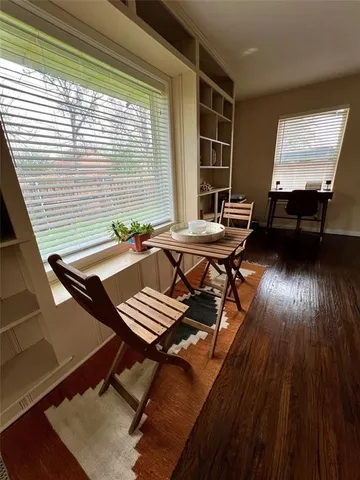 a view of a workspace with furniture and wooden floor