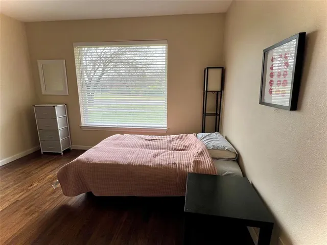 a bedroom with a bed and a chair