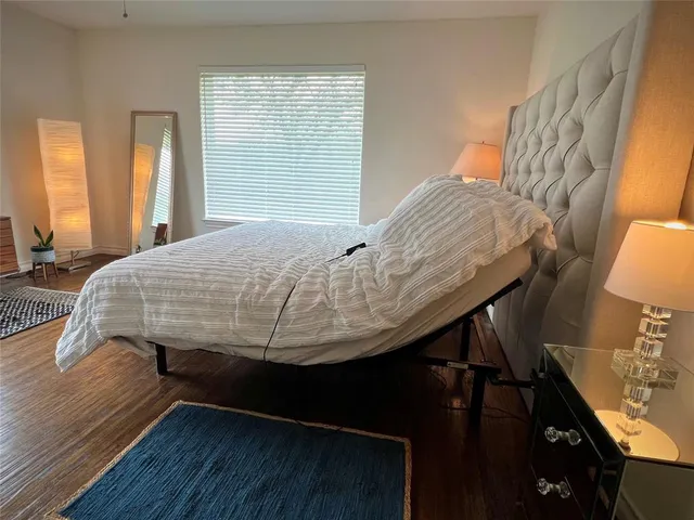 a bed sitting in a bedroom next to a window