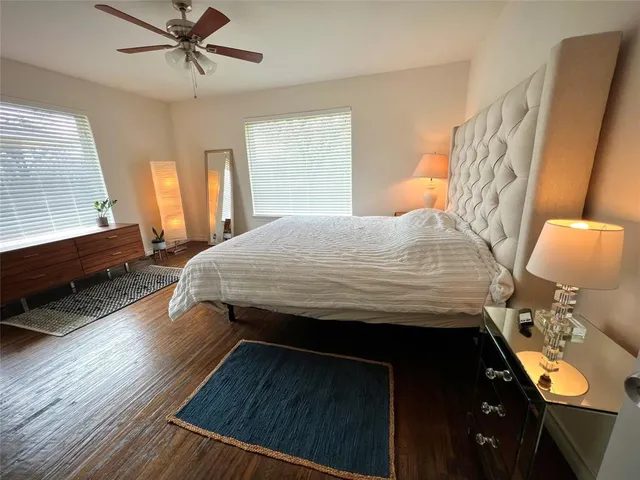 a bedroom with a bed dresser and a window